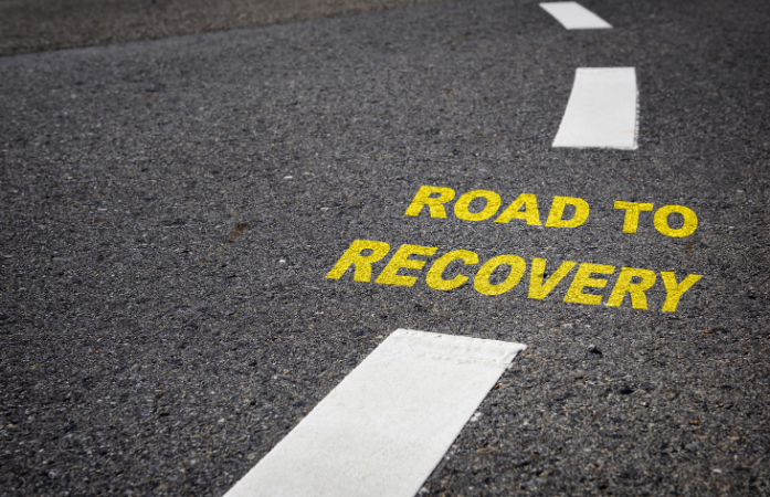 the words road to recovery on a literal road